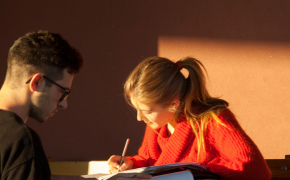 Un ragazzo e una ragazza studiano seduti ad un tavolo