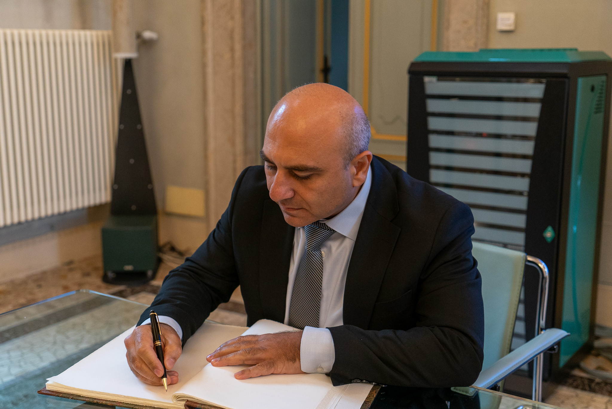 The Ambassador Aslanov signing the Guestbook