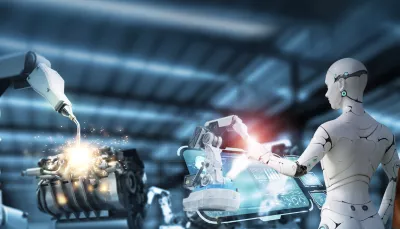 robot controlla macchina mentre viene osservato da uomo