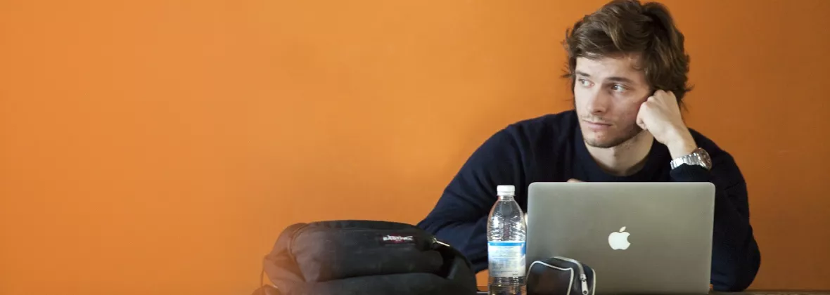 ragazzo che pensa davanti al computer